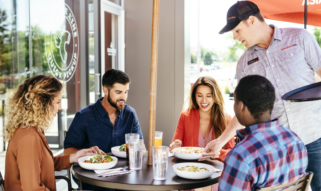 Image of group being served food on patio